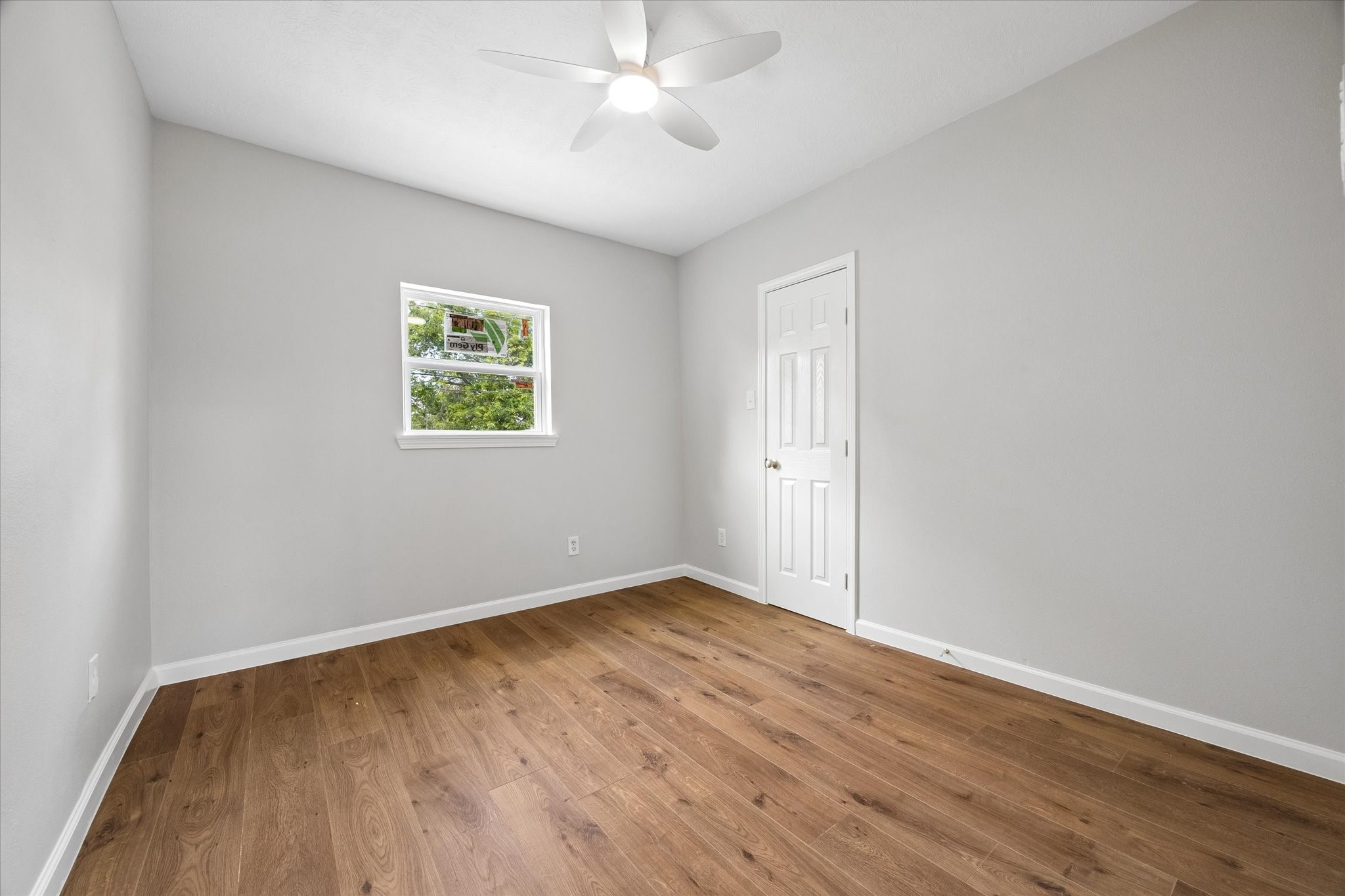 4203 Mowery Road Houston, TX 77047 - Photo 13 of 16 an empty room with wooden floor and windows