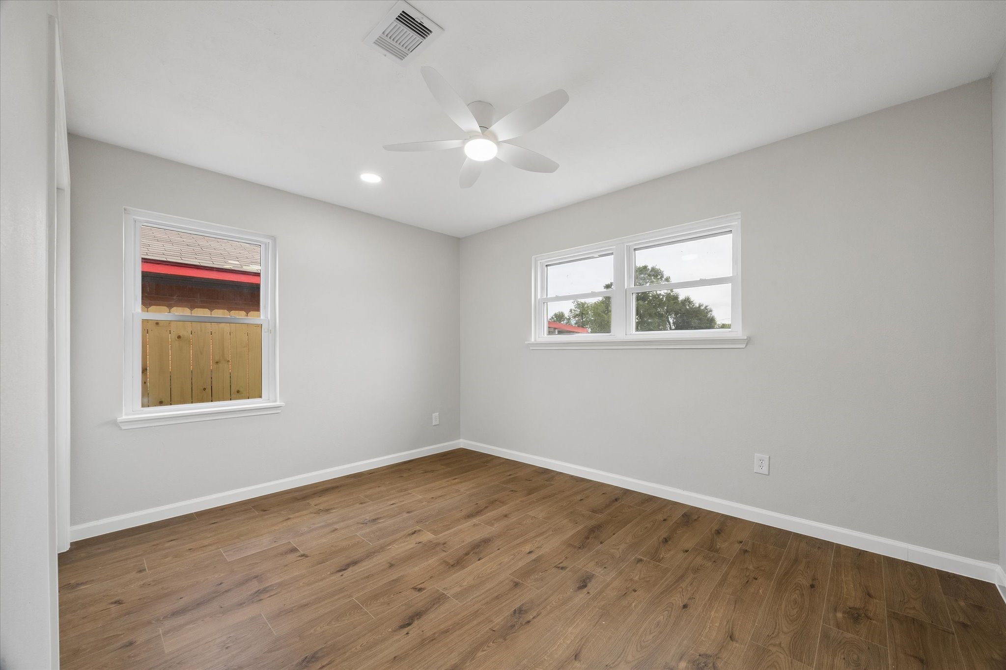 4203 Mowery Road Houston, TX 77047 - Photo 14 of 16 a view of an empty room with wooden floor and a window