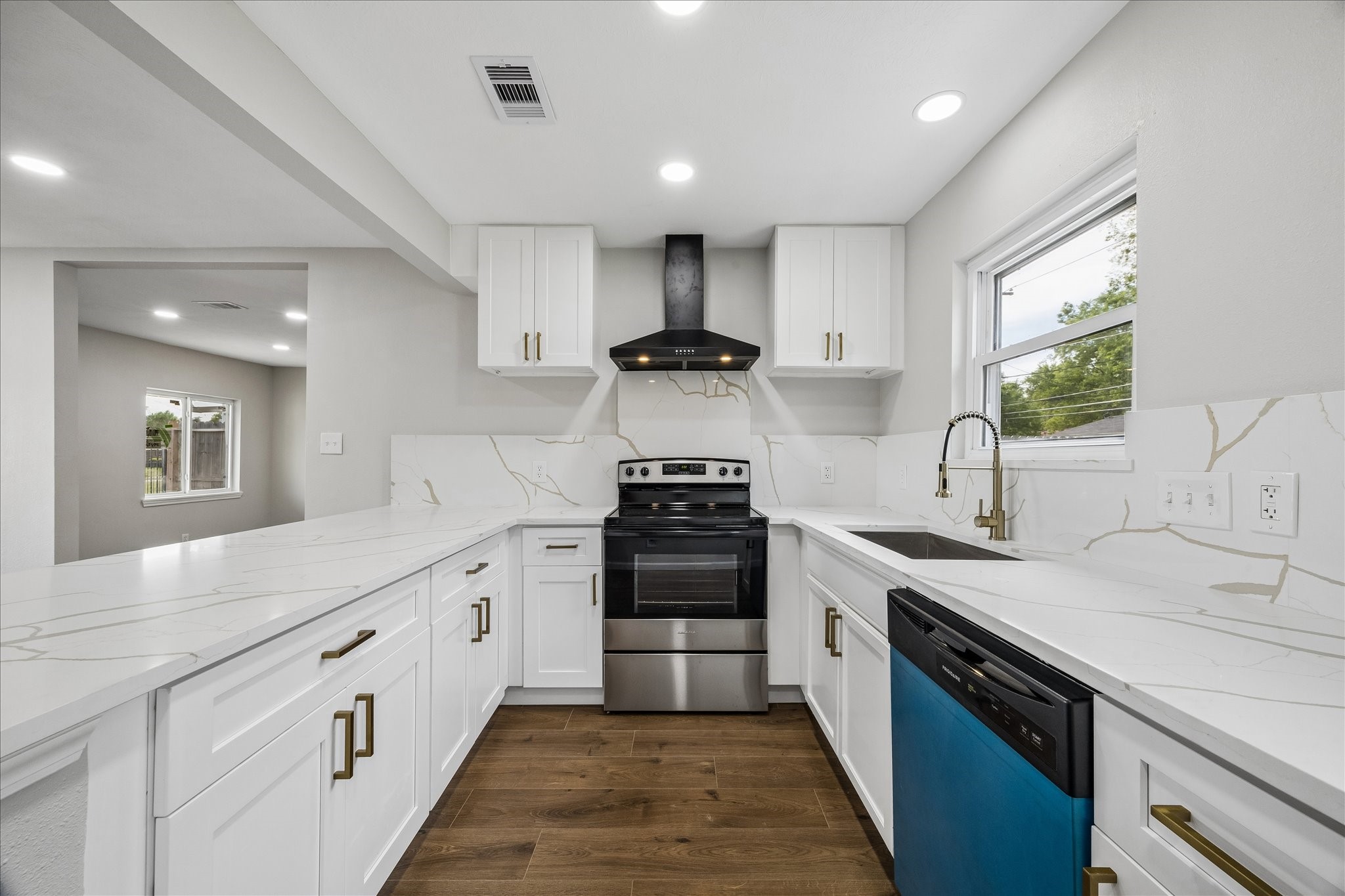 4203 Mowery Road Houston, TX 77047 - Photo 5 of 16 a large kitchen with a stove and a sink