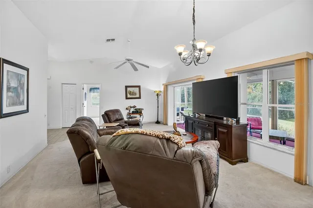 a living room with furniture and a floor to ceiling window