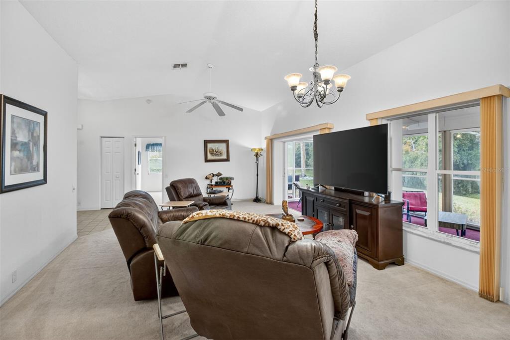 8841 Kipling Avenue Hudson, FL 34667 - Photo 12 of 41 a living room with furniture a flat screen tv and a window