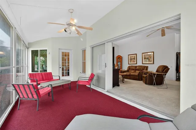 a bedroom with a bed lamp and a large window