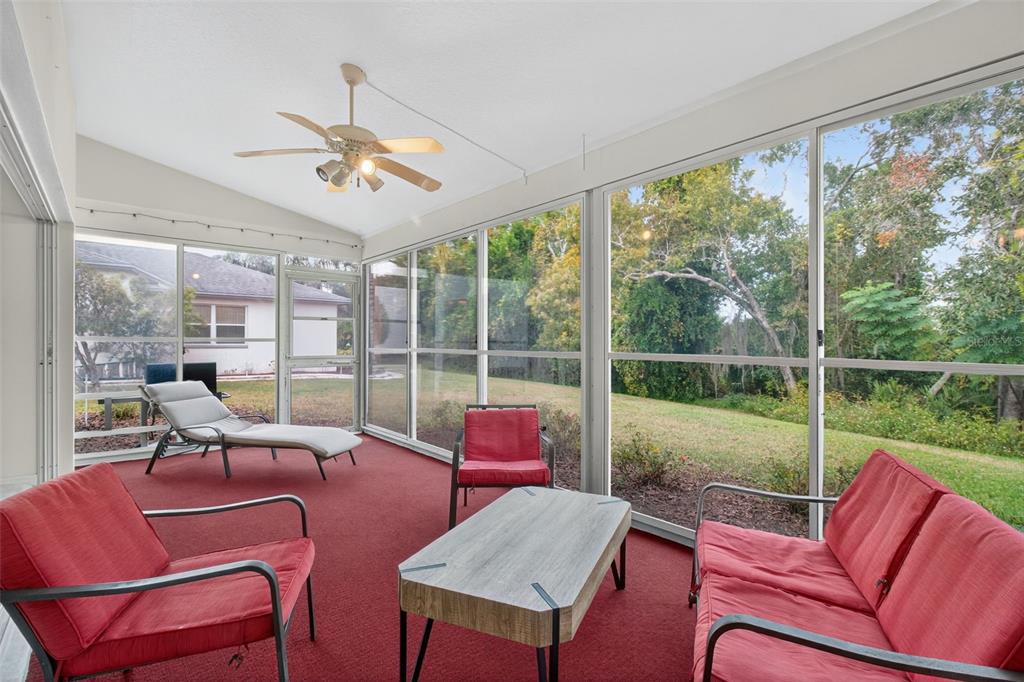 8841 Kipling Avenue Hudson, FL 34667 - Photo 15 of 41 a living room with furniture and a floor to ceiling window