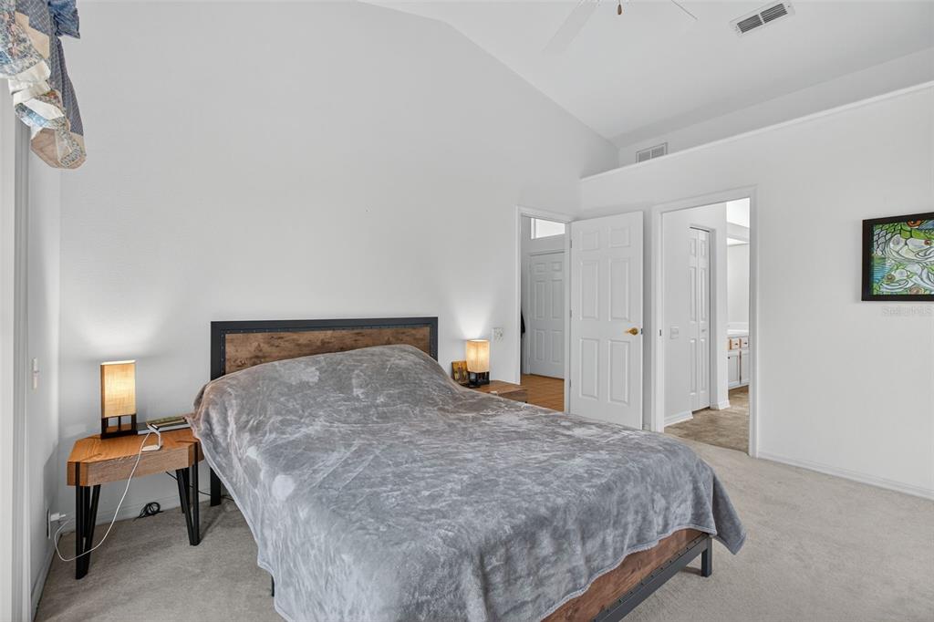 8841 Kipling Avenue Hudson, FL 34667 - Photo 18 of 41 a bedroom with a bed and lamp