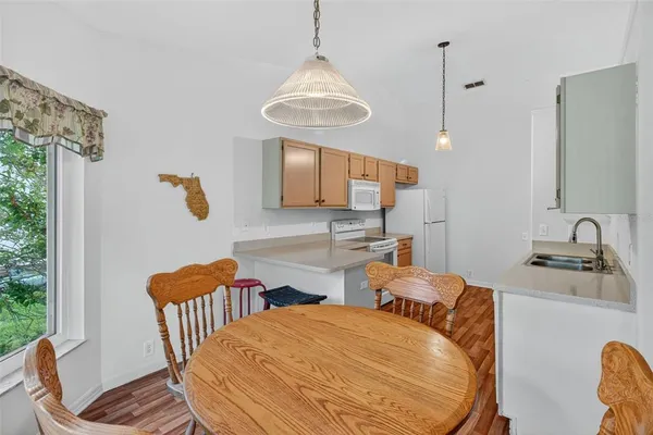 a kitchen with white cabinets and white appliances