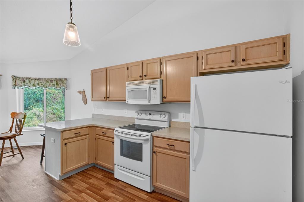 8841 Kipling Avenue Hudson, FL 34667 - Photo 26 of 41 a kitchen with white cabinets and white appliances