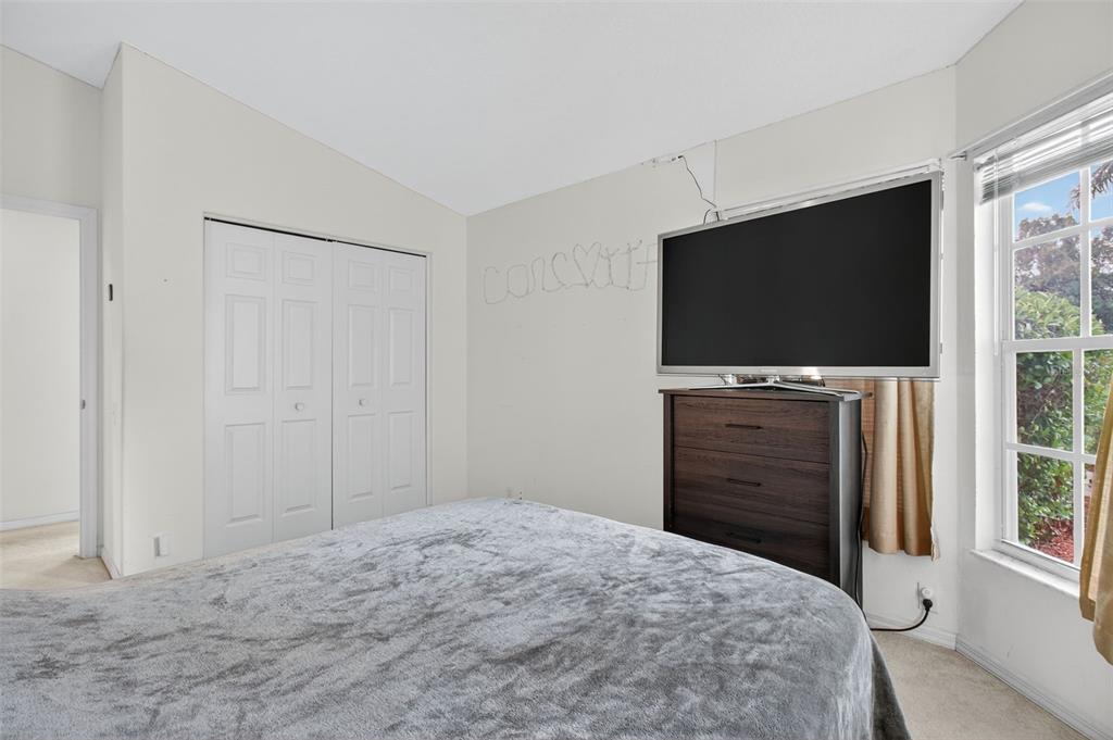 8841 Kipling Avenue Hudson, FL 34667 - Photo 27 of 41 a bedroom with a bed and a flat screen tv