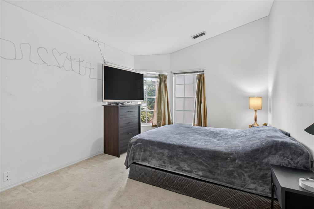 8841 Kipling Avenue Hudson, FL 34667 - Photo 28 of 41 a bedroom with a bed and a flat screen tv