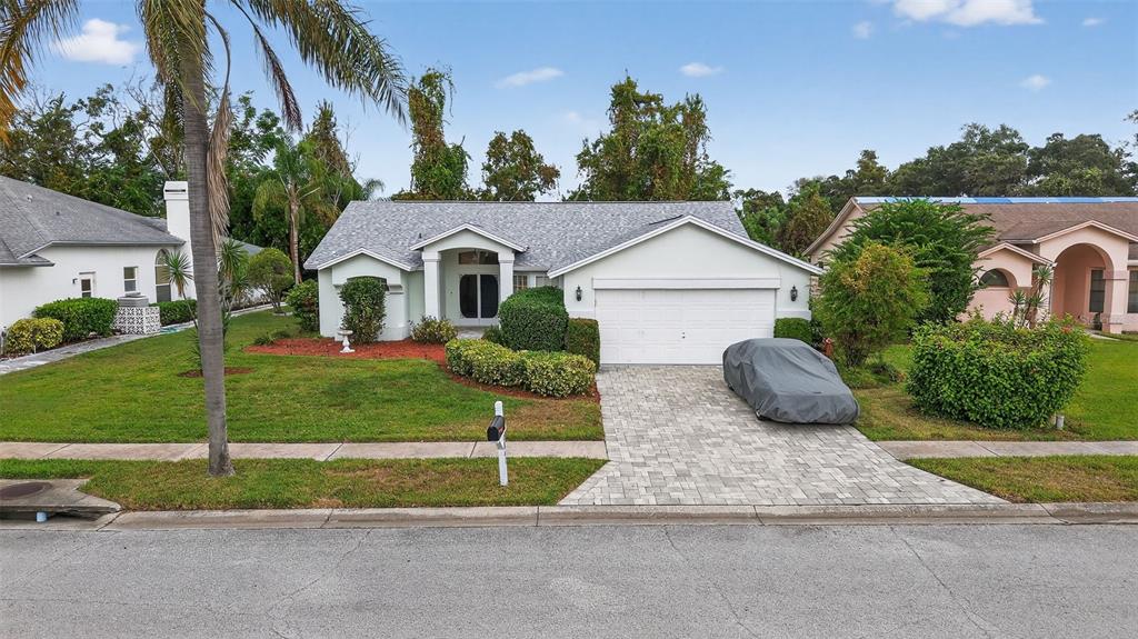 8841 Kipling Avenue Hudson, FL 34667 - Photo 4 of 41 a house view with garden space and trees
