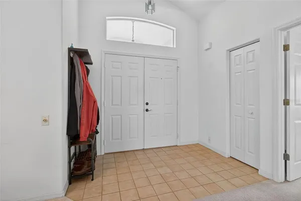 a living room with furniture a fireplace and a chandelier