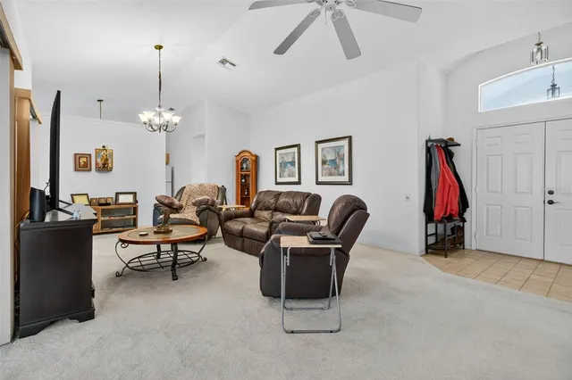a living room with furniture a flat screen tv and a window