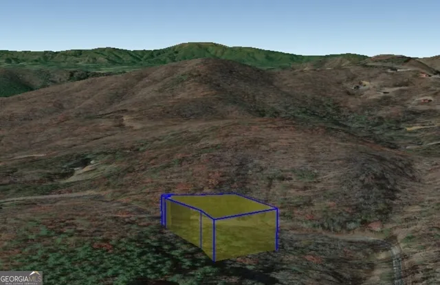 a view of a lush green hillside and a houses