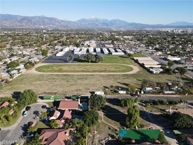 an aerial view of residential houses with outdoor space