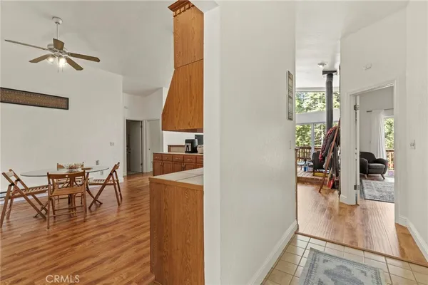 a living room with furniture a flat screen tv and a floor to ceiling window