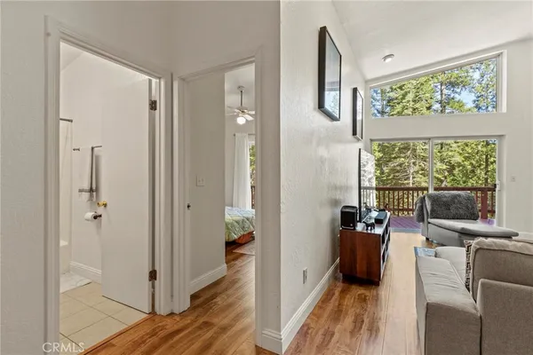 a living room with furniture and large windows