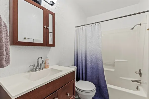 a en suite bathroom with a sink vanity and mirror