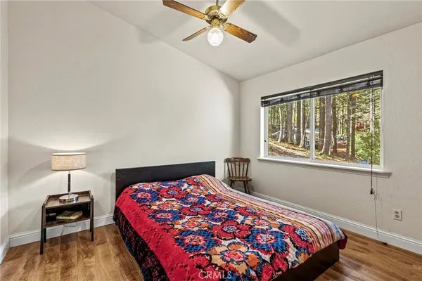 a bedroom with a bed and a lamp on a dresser