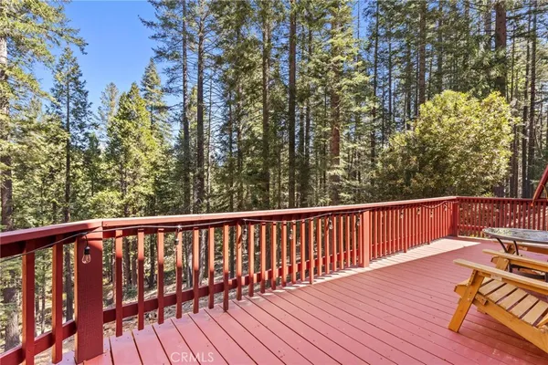 a view of balcony with wooden floor and outdoor seating