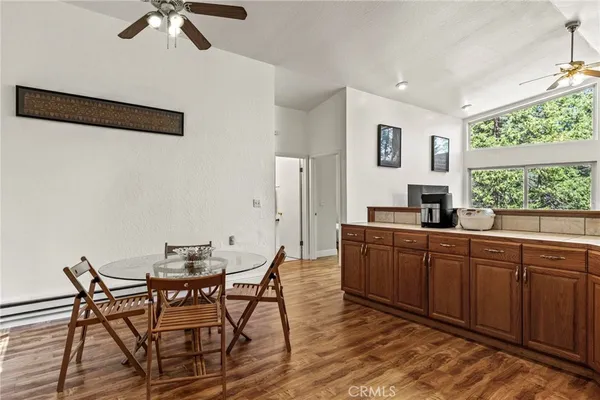 a kitchen with a table chairs stove and kitchen view