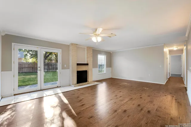 a view of an empty room with window and cabinet
