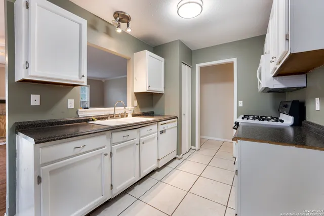 a kitchen with stainless steel appliances granite countertop a sink and cabinets