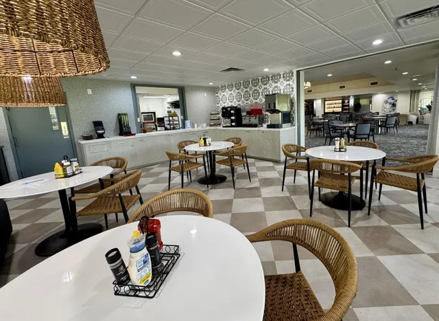 a living room with patio furniture and a large window