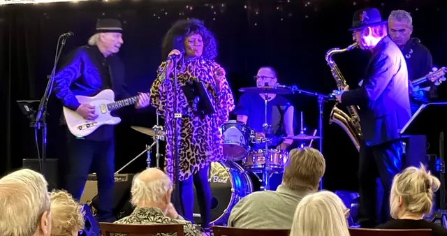 a group of people sitting in front of a window