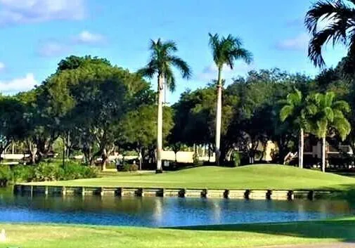 a view of a golf course with a lake