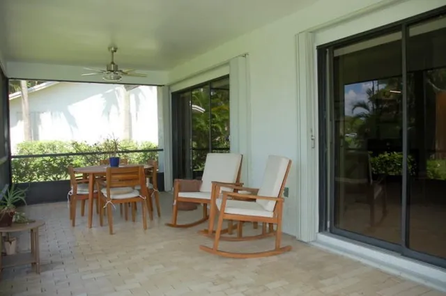 a dining room with furniture and a garden view