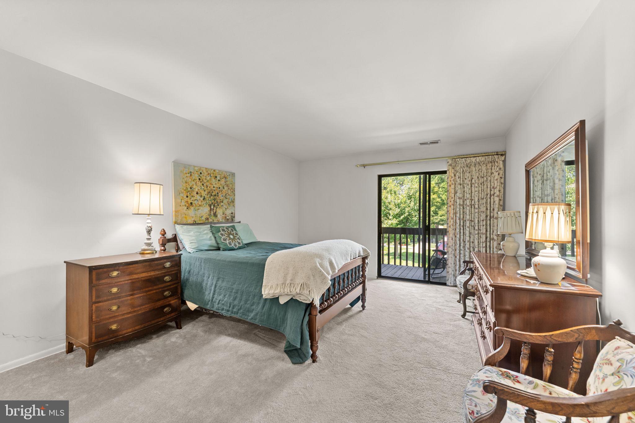 108 Raintree Lane, Unit 108 Malvern, PA 19355 - Photo 14 of 27 Large primary bedroom and access to 2nd balcony.
