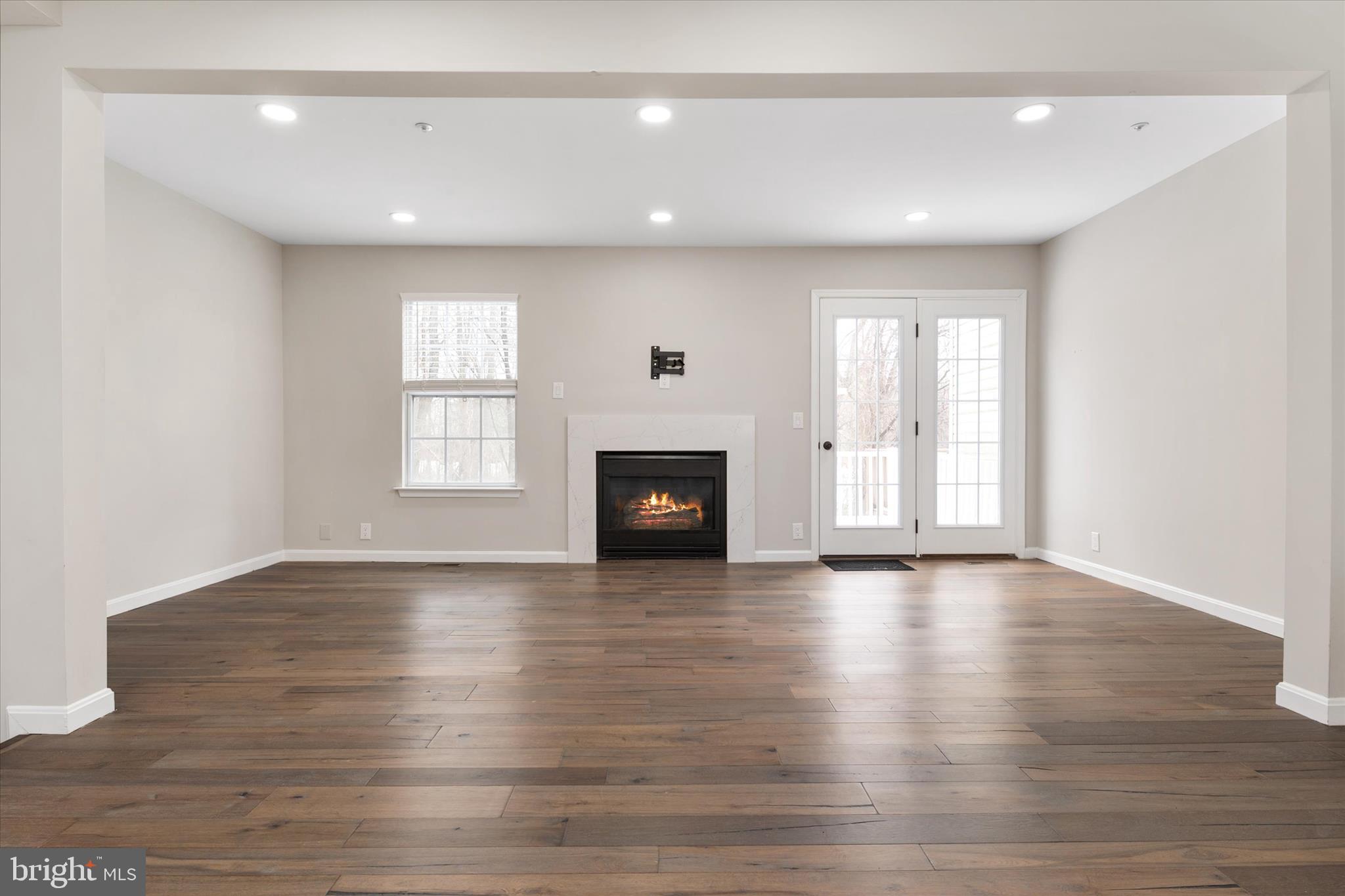 1711 Glebe Creek Way Odenton, MD 21113 - Photo 12 of 33 an empty room with wooden floor and windows