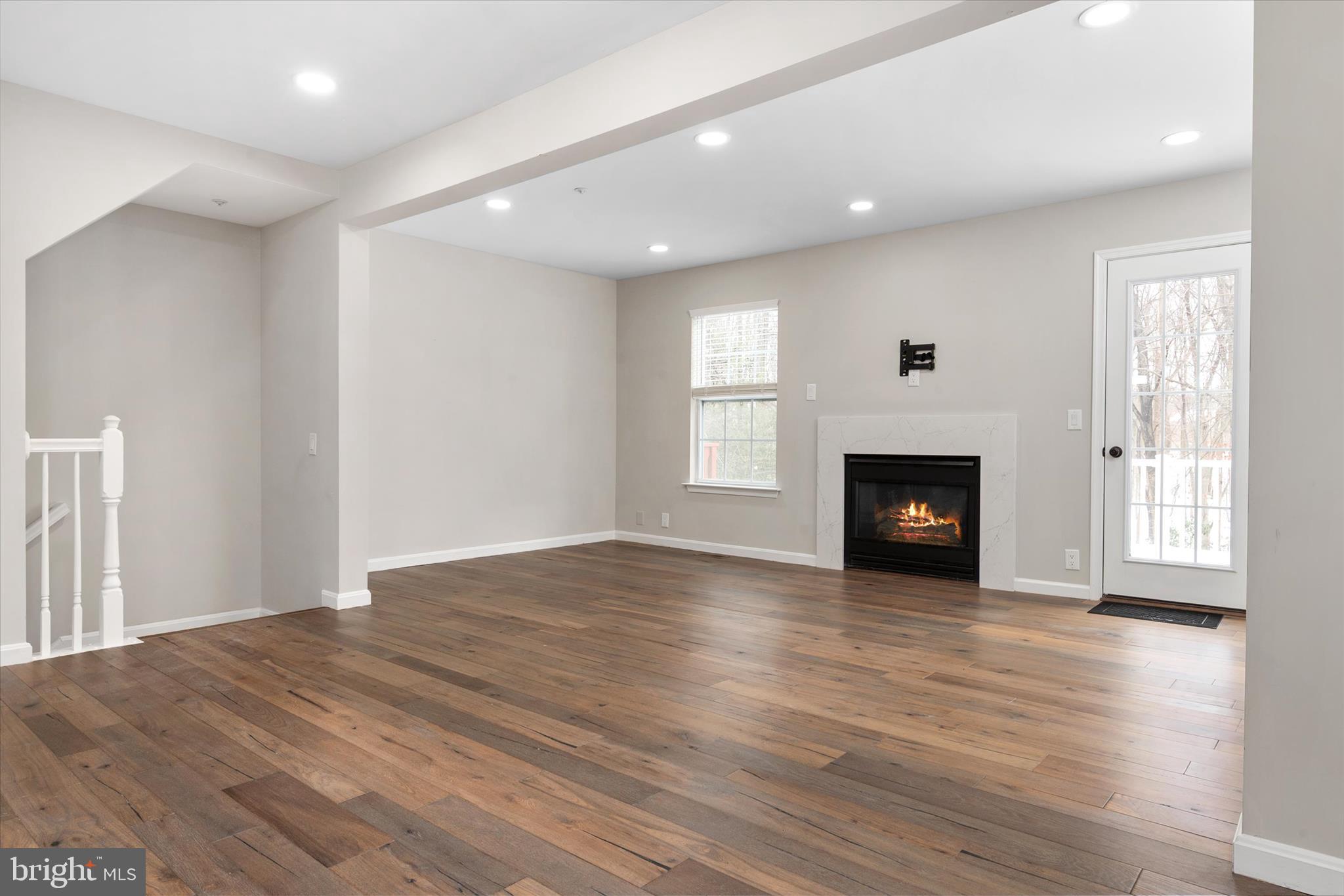 1711 Glebe Creek Way Odenton, MD 21113 - Photo 13 of 33 a view of empty room with wooden floor and fireplace