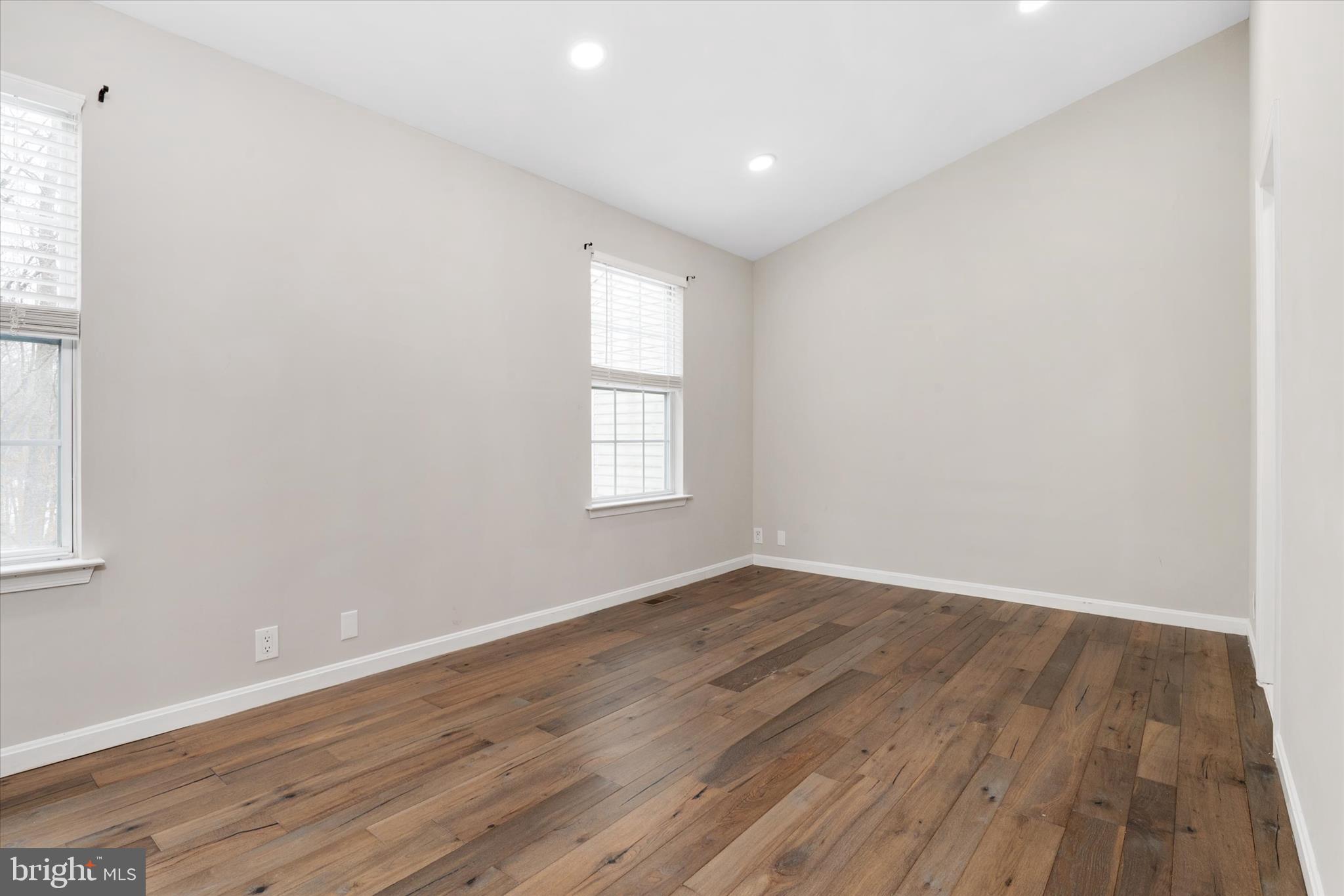 1711 Glebe Creek Way Odenton, MD 21113 - Photo 16 of 33 an empty room with wooden floor and windows