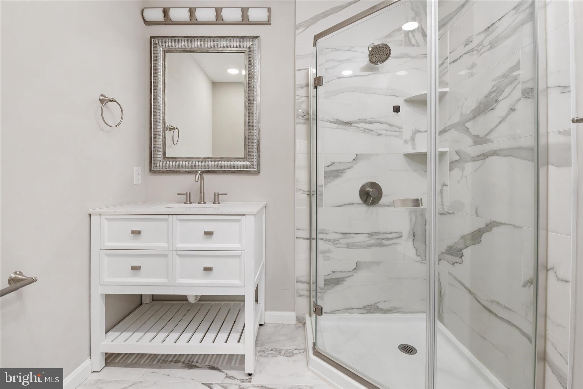 1711 Glebe Creek Way Odenton, MD 21113 - Photo 19 of 33 a bathroom with a shower a sink and mirror