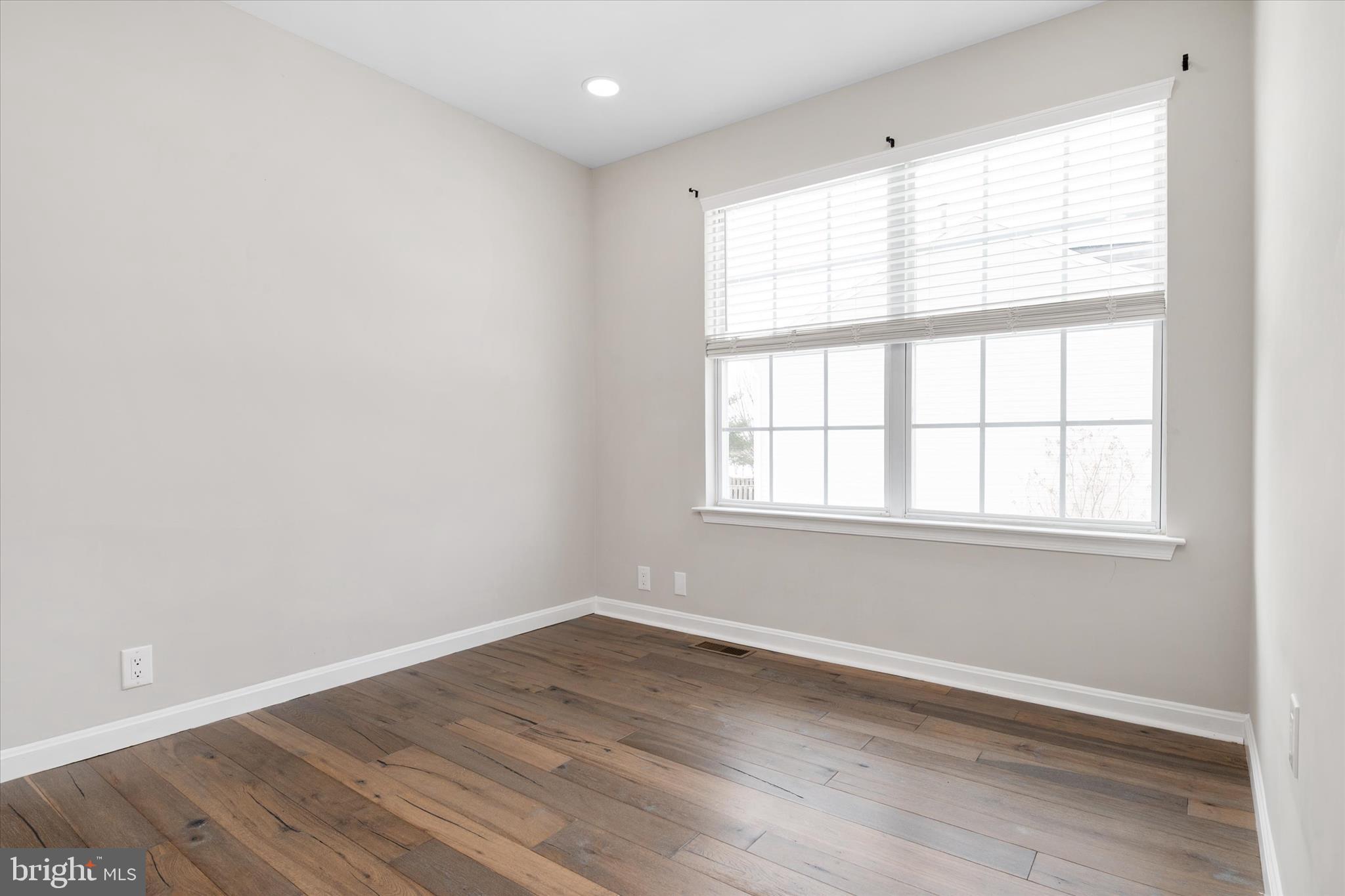 1711 Glebe Creek Way Odenton, MD 21113 - Photo 20 of 33 an empty room with wooden floor and windows