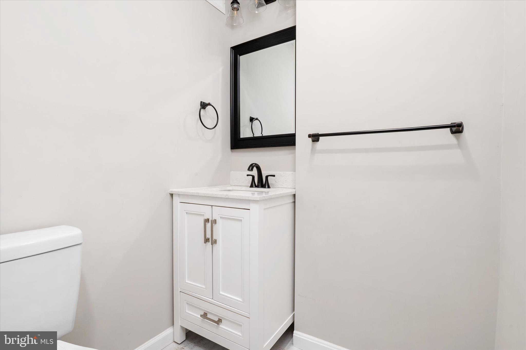 1711 Glebe Creek Way Odenton, MD 21113 - Photo 24 of 33 a bathroom with a sink a toilet and mirror
