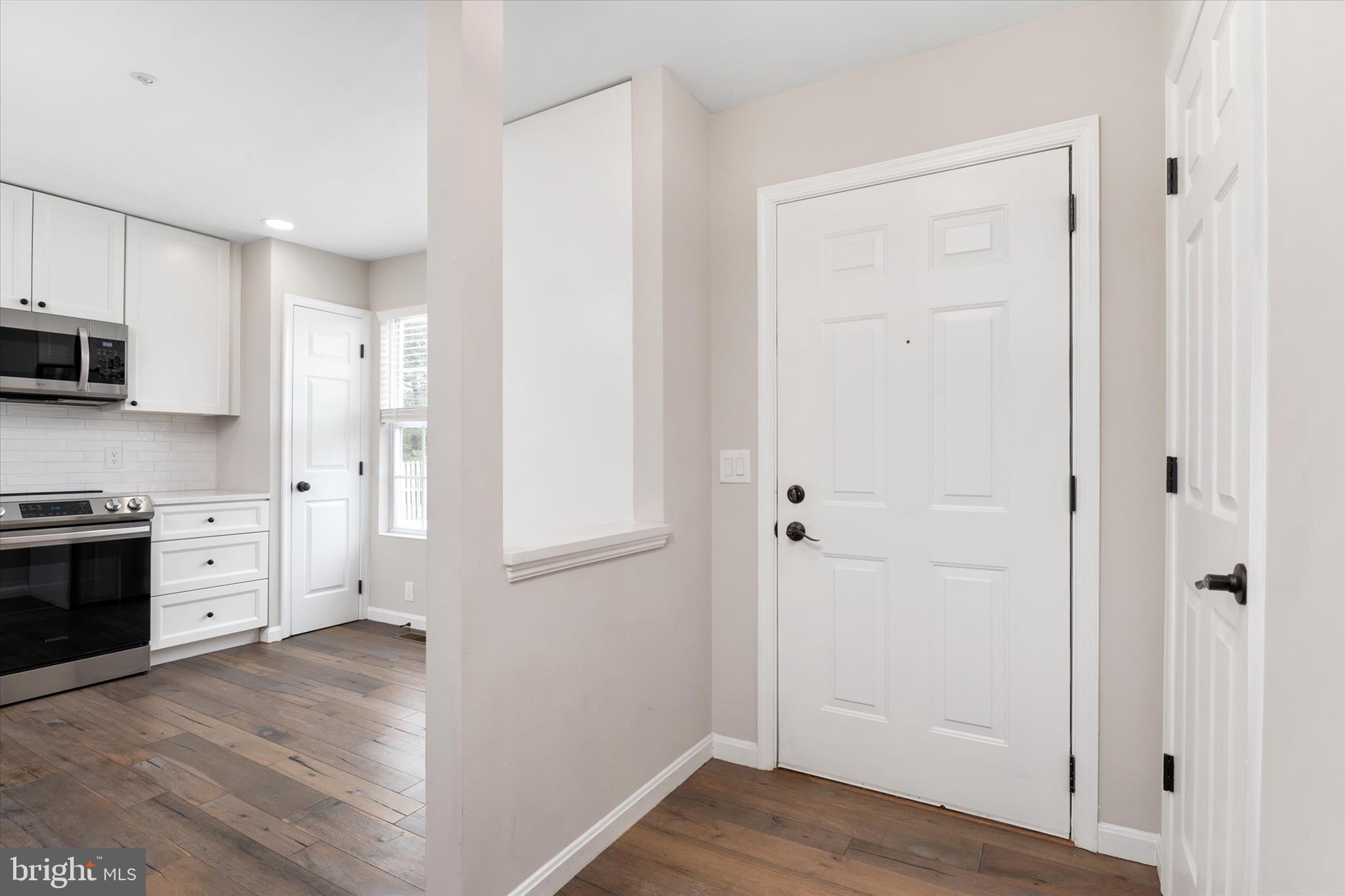 1711 Glebe Creek Way Odenton, MD 21113 - Photo 4 of 33 a kitchen with white cabinets and stainless steel appliances
