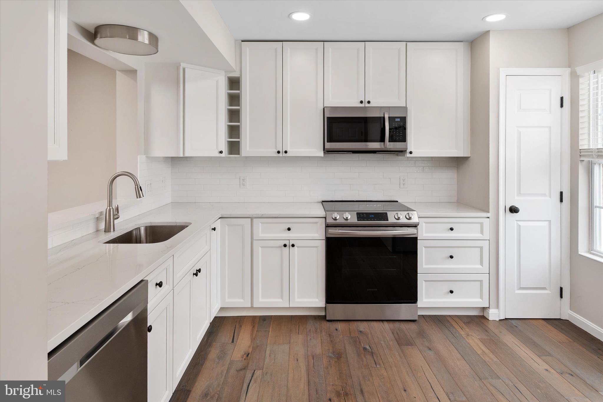 1711 Glebe Creek Way Odenton, MD 21113 - Photo 5 of 33 a kitchen with stainless steel appliances a stove a sink and a microwave