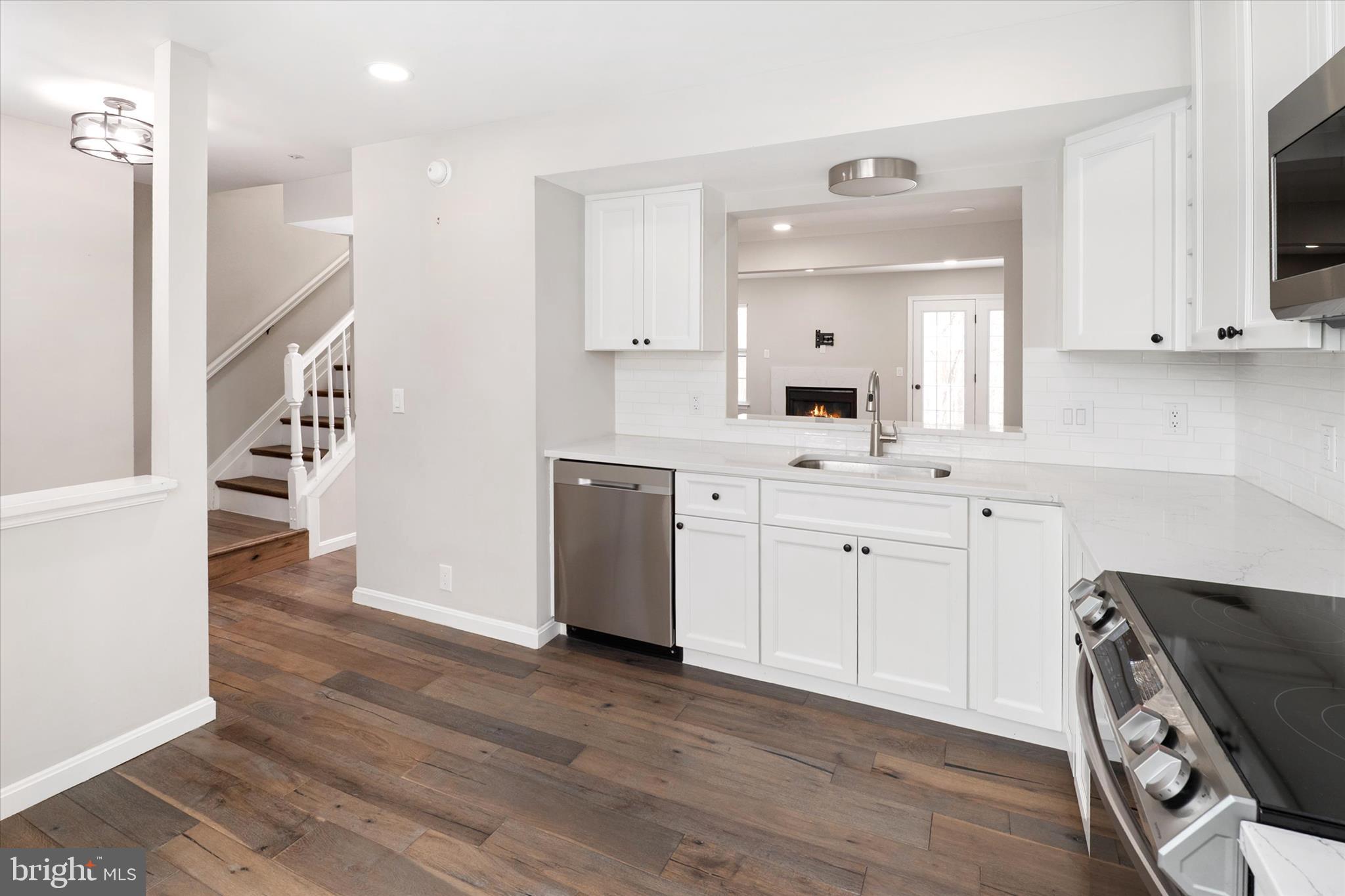1711 Glebe Creek Way Odenton, MD 21113 - Photo 7 of 33 a kitchen with a sink a stove a refrigerator and a window