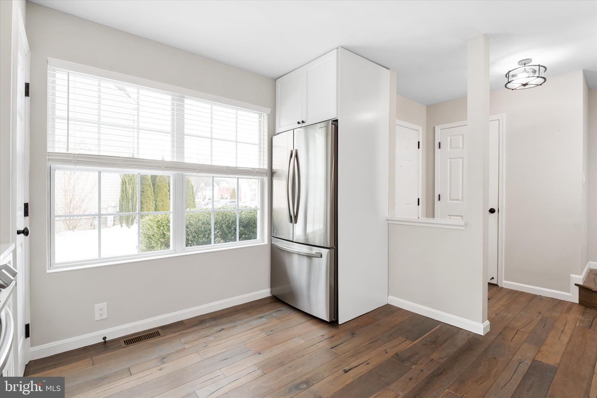 1711 Glebe Creek Way Odenton, MD 21113 - Photo 8 of 33 a view of an empty room with wooden floor and a window