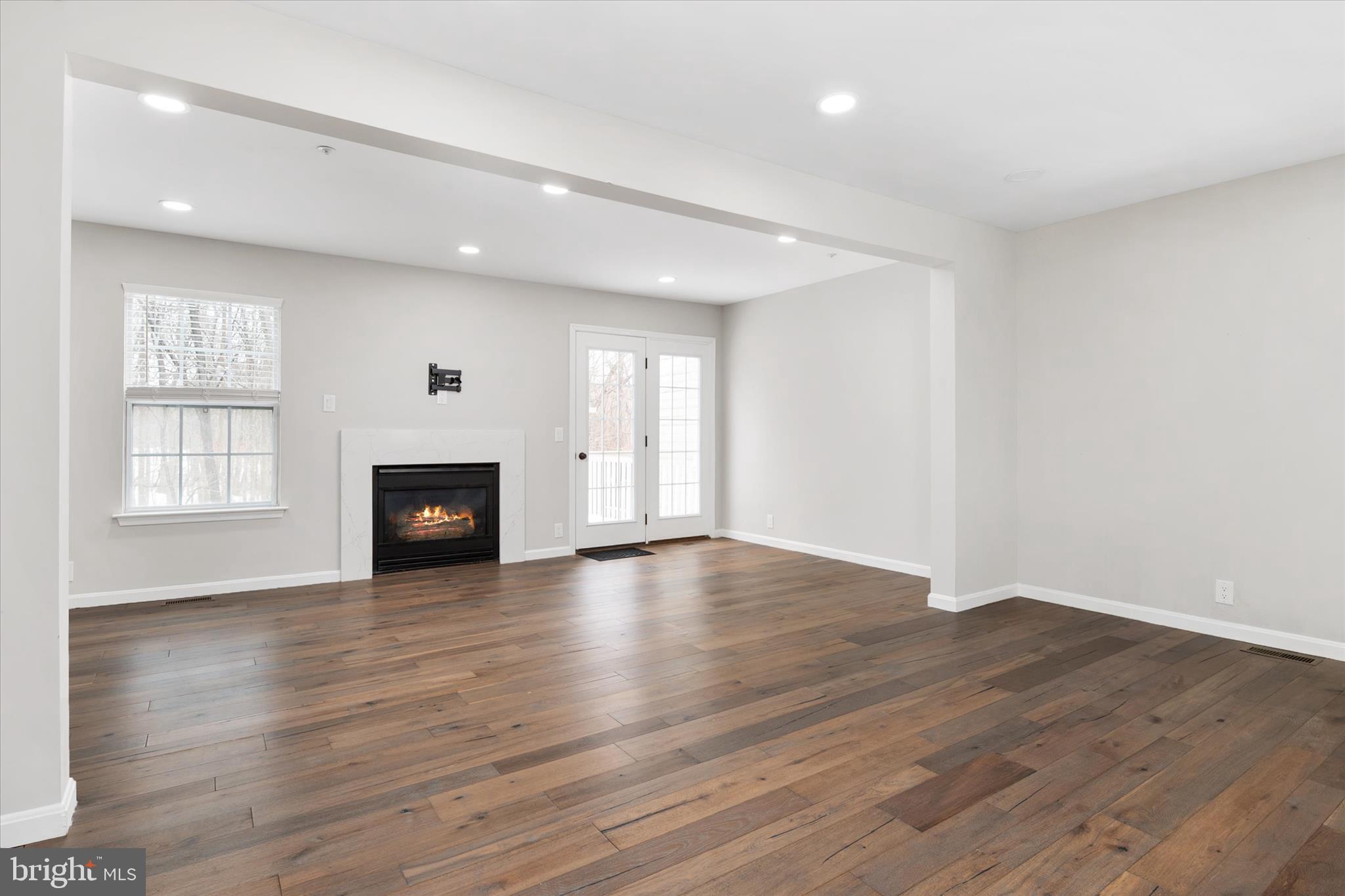 1711 Glebe Creek Way Odenton, MD 21113 - Photo 10 of 33 a view of empty room with wooden floor and fireplace