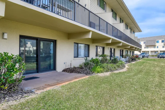 a view of yellow house with a yard