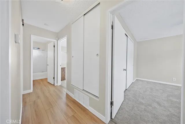 a view of a hallway with wooden floor