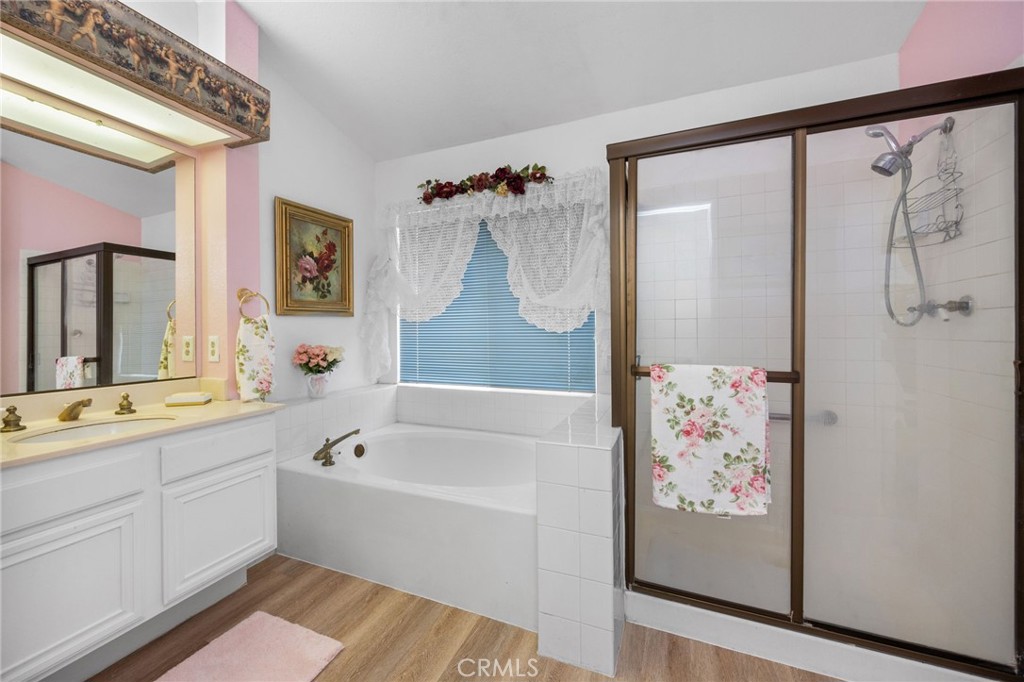 6990 Stanislaus Place Rancho Cucamonga, CA 91701 - Photo 15 of 25 a bathroom with a bathtub a shower a sink and a mirror