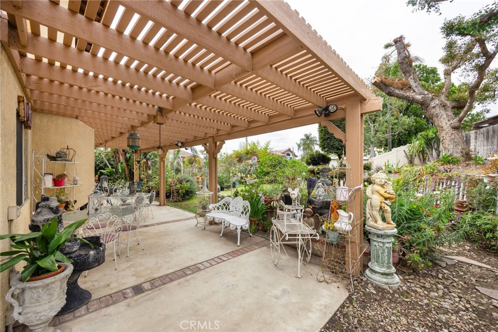 6990 Stanislaus Place Rancho Cucamonga, CA 91701 - Photo 18 of 25 a view of a patio with table and chairs potted plants with wooden floor and seating space