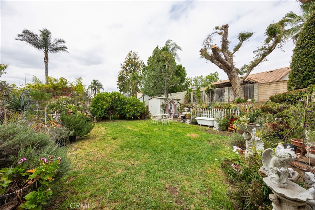 6990 Stanislaus Place Rancho Cucamonga, CA 91701 - Photo 19 of 25 a view of a house with a big yard and potted plants