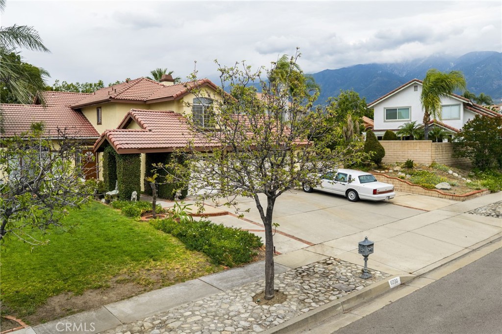 6990 Stanislaus Place Rancho Cucamonga, CA 91701 - Photo 2 of 25 a front view of a house with garden