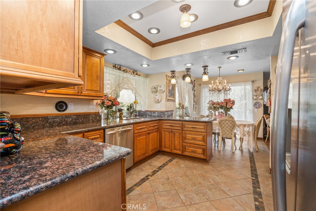 6990 Stanislaus Place Rancho Cucamonga, CA 91701 - Photo 6 of 25 a kitchen with stainless steel appliances granite countertop a sink and cabinets