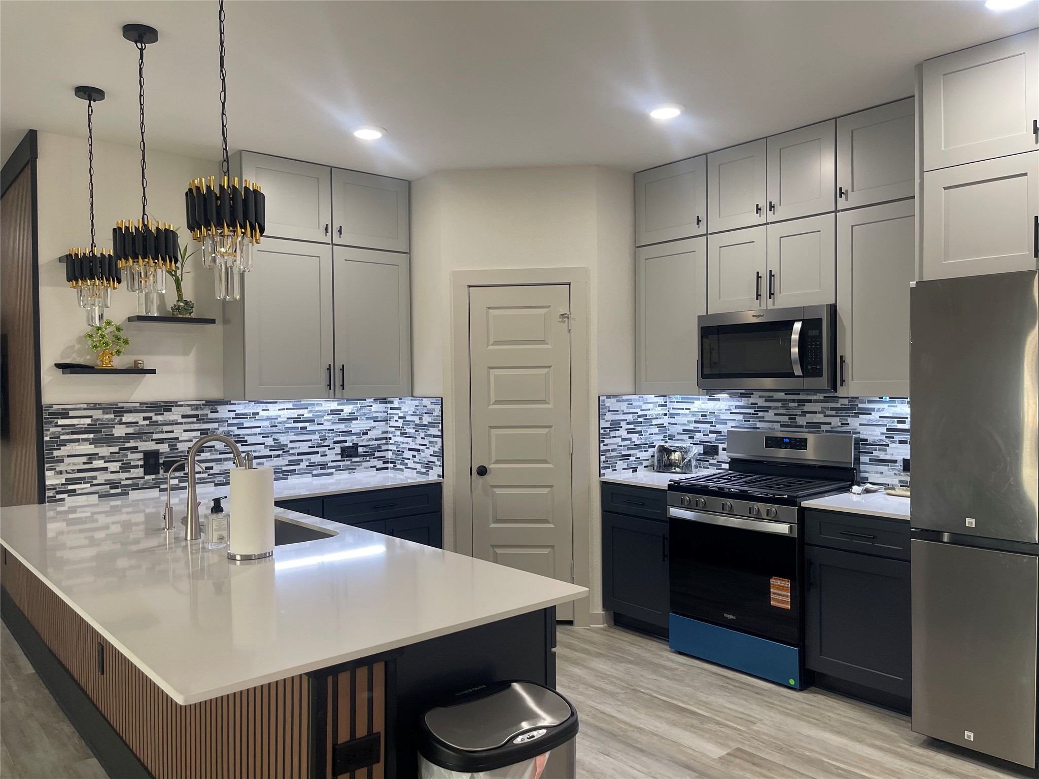 145 Merrick Road Georgetown, TX 78628 - Photo 10 of 32 Modern cabinetry and stone counters define this sleek culinary space with an expansive central island.