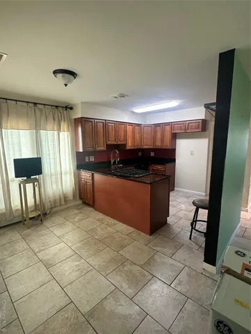 a kitchen with stainless steel appliances a stove a sink and a refrigerator